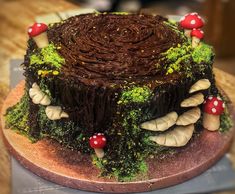 a chocolate cake with mushrooms and grass on top