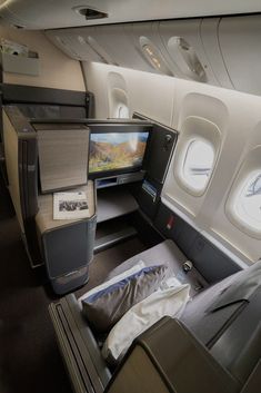 the inside of an airplane with two televisions