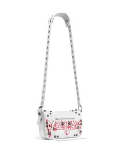 Find BALENCIAGA Le Cagole Xs Diy Metal Messenger Bag on Editorialist. white lambskin text print silver-tone stud detailing adjustable shoulder strap foldover top with magnetic fastening front zip-fastening pocket rear zip-fastening pocket cotton lining main compartment internal zip-fastening pocket We've partnered with Good On You — an independent agency that rates how brands perform in relation to their impact on the planet, people and animals, with a multi-criteria rating simplified to a five Future Wardrobe, Planet People, Text Print, Girly Accessories, Diy Metal, Cute Purses, White Bag, Messenger Bag, Balenciaga