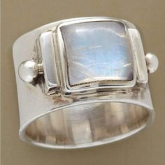 a silver ring with a blue stone in it