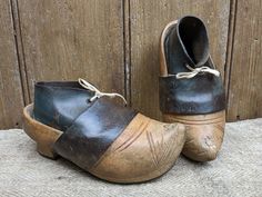 "A pair of antique French wooden & leather clogs from Brittany. They are child sized & make a lovely display. In good condition with some small signs of age & use, including some drying cracks to the wood which are purely cosmetic. Approx. 7 1/2\" long." Girls Clogs, Lace Parasol, Wine Carrier, Clogs And Mules, French Wire, Leather Clogs, Small Signs, Clogs Shoes