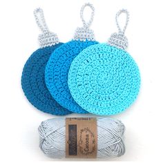 three balls of yarn are next to each other