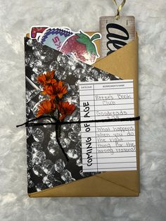 a piece of paper with some flowers and stickers attached to it on a white surface