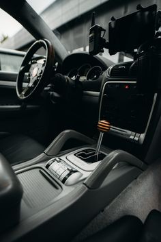 the interior of a car with steering wheel and dashboard controls on it's dash