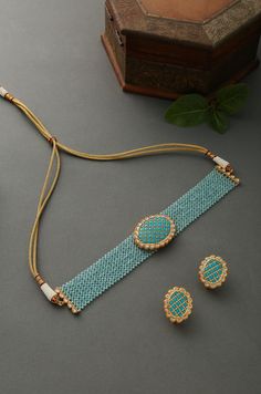 Turquoise gold tone kundan stones choker necklace with earrings. Necklace Choker Length - 14 inches Closure - Adjustable dori Earrings Size - 2.5 cm Style Tip - This pretty necklace is sure to take your wedding dressing game a notch higher with much ease. We love to see this one on rich chiffon sarees or classic black angrakha kurtas. This stunner of a necklace set is meant for royalty and is sure to fetch you compliments in plenty. Handcrafted in Jammu and Kashmir Paisley Pop travels the depths Black Angrakha, Wedding Dressing, Necklace Closure, Necklaces Choker, Chiffon Sarees, Choker Necklace Designs, Beads Choker, Antique Jewellery Designs, Jewelry Set Design