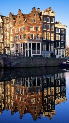 some buildings are reflected in the water