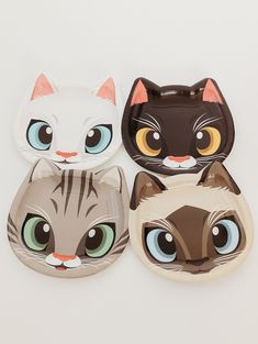 three paper plates with cats on them, one has blue eyes and the other has green eyes