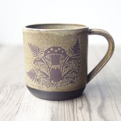 a coffee cup sitting on top of a wooden table