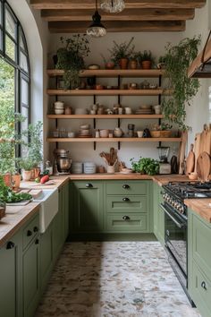 a kitchen with green cabinets and wooden shelves