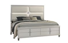 a white bed sitting next to a night stand