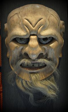 an old mask with long hair and beard