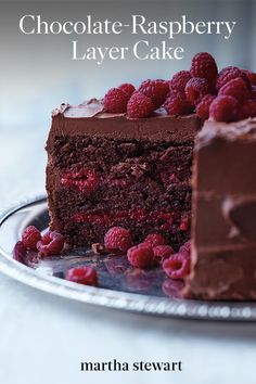 a piece of chocolate cake with raspberries on top and one slice missing from it