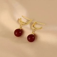 Elevate your style with these stunning red pearl dangle earrings from Barbie Brides. The 14K gold-plating and excellent cut cubic zirconia stones make these earrings perfect for any occasion - from engagements and weddings to birthdays and Valentine's Day. The intricate design and red and gold color combination add a touch of beauty and luck to any outfit, while the fairytale and fantasy theme brings a touch of whimsy. These earrings are made with nickel-free materials, ensuring that they are safe and comfortable to wear all day long. Red Pearl Earrings For Formal Occasions, Elegant Red Hoop Earrings For Formal Occasions, Formal Red Pearl Earrings With Matching Set, Elegant Red Pearl Earrings For Formal Occasions, Red Pearl Drop Earrings For Formal Occasions, Elegant Red Dangle Pearl Earrings, Elegant Red Drop Earrings, Elegant Ruby Hoop Earrings For Anniversary, Elegant Red Pierced Earrings