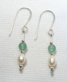 These earrings are Freshwater Pearl and Aventurine. They are sterling silver. Their overall length including earwires is about 1 1/4". The Pearls are nicely shaped with good lustre, 5 mm in length. The Aventurine stones are 4 mm rounds. The pair shown is the one you will receive. Handmade by us.      Lyn's Jewelry, in business operating out of Sunny Syracuse since 1989. Silver And Stone Earrings, Silver Pearl Jewelry, Drop Earrings Silver, Freshwater Pearl Drop Earrings, Aventurine Stone, Handcrafted Artisan Jewelry, Creative Jewelry, Silver Drop Earrings, Pearl Drop Earrings