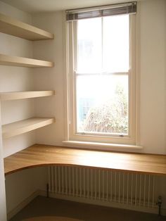 a empty room with shelves and a window