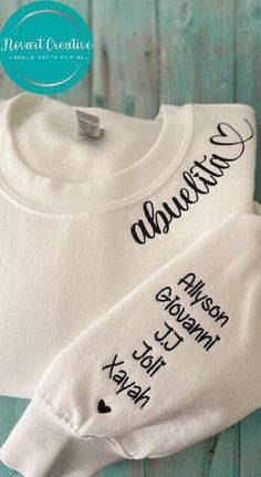 Thank you for your interest in our store. Per our shop update, orders placed now will be shipped out no earlier than 2 weeks, excluding USPS shipping time! Orders will not be delivered by Christmas. This Embroidered Abuelita Sweatshirt featuring grand kids names is a perfect gift for birthday, mother's day or any other special occasion. This unique gift will surely make any abuela feel so special and loved!  👉Embroidered Crewneck Sweatshirt ●Please note the more names on the sleeve the smaller size font will be used, no double names in one line please ● Up to 7 names on one sleeve. If you want to have names on both sleeves (up to 7 names on each sleeve) it will be a custom order with additional $7 charge. ● If order is placed for both sleeves without requesting a custom order it will be c Personalized Cotton Sweatshirt As Gift, Custom Name Cotton Sweatshirt For Gift, Lili Art, Grandma Embroidery Sweatshirt, Auntie Sweatshirt With Names, Embroidered Grandma Sweatshirt, Double Names, First Time Grandma, Great Grandma Gifts