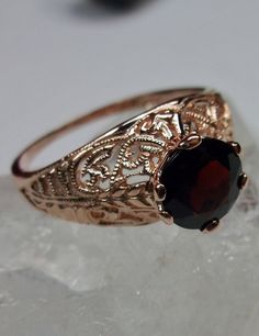 Natural Red Garnet Gold Ring Corset Design#199 Custom Made This is a stunning Art Deco reproduction in sterling silver and rose gold plating (or solid gold 10k, or 14k) filigree with a 1ct natural garnet. The garnet is 8mm in diameter. The inside of the band is marked 925 for sterling. Can choose solid gold 10k or solid gold 14k. Notice the beautiful craftsmanship of the rose gold filigree setting and band. This is a ornate and detailed ring. This is a lovely rendition of an antique filigree rin Garnet Gold Ring, Ruby Diamond Engagement Ring, Pink Topaz Earrings, Oval Halo Engagement Ring, Promise Rings Vintage, Gold Leaf Rings, Bridesmaid Rings, Turquoise Gold Ring, Gemstone Art