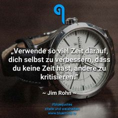 a watch sitting on top of a table next to a quote from john rohn