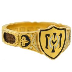 This rare English mourning ring from the Victorian (ca1879) era is quite an unusual piece! Crafted in 18kt gold, the ring is richly detailed, and serves as a fine example of the mourning jewelry tradition. Black and white enameled accents decorate the shoulders of the ring and the shield-shaped seal at the center. Multiple cut out "windows" along the shank expose a band of finely woven hair below, the keepsake of a lost loved one. Completing the design are fine etched details that carry around the entire exterior of the setting. A full commemorative inscription with date of death can be found inside the shank, which reads: "M.A. Vincent, née Mourant, died 2nd Jan. 1879." Several English hallmarks are also stamped inside, including: the maker's initials "A&S,&qu Domed Ring, The Ring, Black Enamel, Signet Ring, Jewelry Trends, Estate Jewelry, Pearl Jewelry, Birmingham, 19th Century