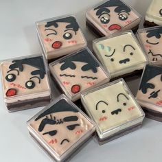 many small square cakes with faces on them