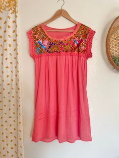 This beautiful vintage Mexican dress is a must-have for any bohemian-inspired wardrobe. Made of soft cotton material, this dress features intricate floral embroidery in a stunning coral color. The dress has a round neckline, short sleeves, and a pullover closure, making it perfect for casual occasions during the spring and summer seasons. The dress is handmade and has a quality feel, adding to its charm. This dress is perfect for anyone who wants to add a touch of bohemian flair to their wardrobe. Measurements taken while laying flat: Pit to pit- 20.5" Waist- 25" Length- 34.5" Vintage Mexican Dress, Wardrobe Measurements, Mexican Dress, Boho Mini Dress, Mexican Dresses, Vintage Mexican, Denver Co, Coral Color, Floral Embroidery