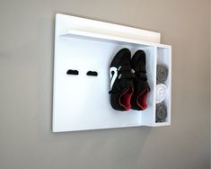 there is a pair of shoes on the wall with two pairs of shoes in it