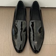 Hugo Boss - Black, Patent Leather Slipper Sophisticated, Sleek, Black Patent Leather Slip On Loafer With Silk Grosgrain Ribbon Trim Covering All Edges. Seamless Flat Front With An Almond Shaped Toe, Lightly Padded Footbed And Notches On Each Side Of The Tongue Giving You That Fashionable Slipper Look. Leather Upper. True To Size. Made In Italy. Never Worn. No Box. Smoke Free, Pet Free Home. Luxury Patent Leather Loafers With Leather Footbed, Hugo Boss Woman Shoes, Hugo Boss Shoes Women, Black Slip-on Dress Shoes For Formal Occasions, Classic Patent Leather Party Loafers, Classic Patent Leather Loafers For Party, Sleek Black Loafers With Leather Sole, Classic Slip-on Dress Shoes For Party, Classic Black Dress Shoes For Parties