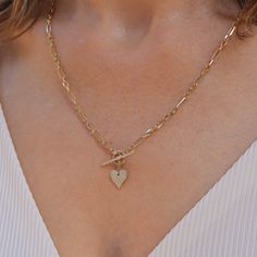 Add a romantic touch to your layered necklaces with this dainty heart necklace made of gold. A perfect heart hanging from a marvelous staple chain. This fine necklace is easy to wear with everything, fits perfectly with other necklaces, and also looks fabulous on it's own. This is a must-have necklace. All features can be customized! Talk to us Our jewelry is carefully handmade in our atelier Our diamonds are conflict free To order by phone click here>> +972(0)722991000 Elegant 14k Gold Filled Heart Necklace, Dainty Heart-shaped Charm Necklace With Cable Chain, Dainty Heart Pendant Charm Necklace With Cable Chain, Dainty Gold Plated Heart Necklace, Valentine's Day Charm Necklace With Cable Chain, 14k Gold Filled Heart Charm Jewelry For Wedding, Elegant Heart Pendant Chain Necklace With Delicate Chain, Elegant Heart Pendant Chain Necklace, Yellow Gold Necklaces With Delicate Chain For Valentine's Day