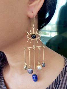 Chunky Evil Eye Long Statement Dangle Earrings, Chandelier Lapis Earrings, Boho Style Gold Brass Earrings  Why these earrings can be a perfect gift for your loved one or you? - Comes in great packaging, with a re usable storage box & a silk pouch.  - Perfect for all occasions. - You can add a personal message to your order.  To make your purchase a special gift for your friend or family, you can choose from our pre made relationship cards.  PLEASE SELECT THE RELATIONSHIP CARD WHILE CHECKING OUT. FOR REFERENCE GO THROUGH THE LAST IMAGE OF THE LISTING.  Specifications -  Gemstone  - Natural Lapis, Labradorite, Pearl  Length  - 4 inches approx  Find the best pair of earrings for your beautiful ears here -  https://www.etsy.com/shop/TheEnache?ref=seller-platform-mcnav&section_id=28306680 ** IM Bohemian Party Jewelry With Ear Wire, Chandelier Dangle Earrings With Dangling Charms For Gift, Gift Chandelier Dangle Earrings With Charms, Bohemian Chandelier Earrings With Dangling Beads For Party, Bohemian Chandelier Earrings For Party, Bohemian Long Drop Chandelier Earrings For Parties, Teardrop Dangling Charms Jewelry For Party, Bohemian Dangle Earrings For Party, Bohemian Dangle Chandelier Earrings For Parties