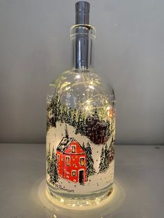 a glass bottle with a red house on it