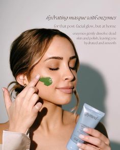 a woman with green leaves on her face holding up a tube of cream to her face