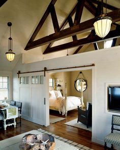 a bedroom with wooden beams and white walls