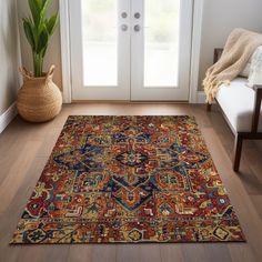 a large rug is on the floor in front of a door with a potted plant