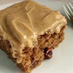 a close up of a piece of cake on a plate with a knife and fork