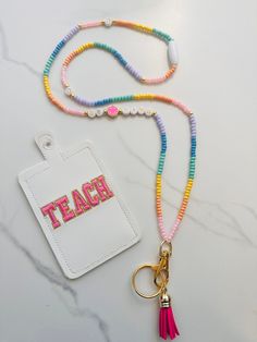 a lanyard with a name tag and a keychain attached to it on a marble surface