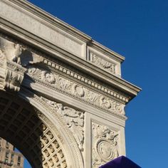 an umbrella is in front of the arch