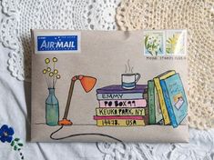 an envelope with some books and a lamp on it