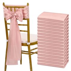 a stack of pink napkins sitting on top of a chair next to a pile of chairs