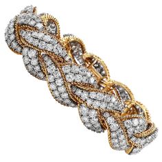 This Intricate yet Sparkly Piece is crafted in solid 18-karat Yellow & White Gold, weighing 83.7 Grams and measuring 6 ½” around the wrist x 18mm wide. Composed of a braided design of 18K Yellow Gold & elongated cluster design textured white gold links, and pave-set with 268 round-cut diamonds, weighing approximately 23.10 carats, graded G-H color and VS clarity. Secures with an Invisible insert clasp, Stamped with purity mark. In Excellent condition, This purchase is accompanied by a profession Buccellati Bracelet, Emerald Diamond Earrings, Diamond Sapphire Engagement Ring, Sapphire Diamond Engagement, Marquise Diamond Engagement Ring, Emerald Cut Diamond Engagement, Marquise Shape Diamond, Cluster Design, Three Stone Diamond Ring