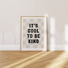 there is a framed poster on the floor with it's cool to be kind