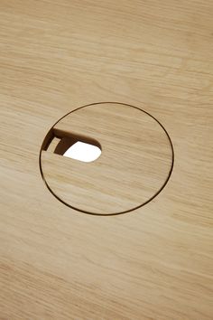 a wooden surface with a hole in the middle