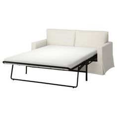 a white couch with a pull out bed on it's backrest and black legs