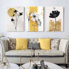 three paintings on the wall above a couch in a living room with white furniture and yellow pillows