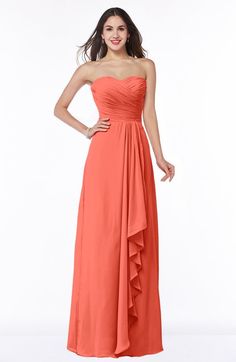 a woman in an orange strapless dress poses for the camera with her hands on her hips