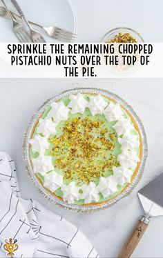 a pie sitting on top of a table next to a knife and fork with the words sprinkle the remaining chopped pistachio nuts over the top of the pie