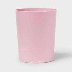 a pink cup sitting on top of a white table