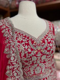 Rose red decorated with silver zari thread embroidery on the surface of the anarkali and highlighted in sequence and resham work. Paired with thread and sequence embroidered dupatta. Fabric: Georgette Size: 40/L Occasion: Wedding Events WASH CARE INSTRUCTIONS - Please Dry clean only when it is applicable. Slight color variation is possible due to photography Ready to Ship! Semi-stitched Silver Anarkali Set For Festivals, Red Anarkali Set With Mirror Work And Traditional Drape, Red Anarkali Set With Mirror Work, Silver Semi-stitched Anarkali Set With Mirror Work, Traditional Silver Salwar Kameez With Resham Embroidery, Silver Anarkali Salwar Kameez With Dabka Work, Silver Bollywood Dupatta With Dabka Work, Festive Silver Sharara With Intricate Embroidery, Festive Silver Dupatta With Dabka Work