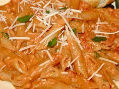 pasta with sauce and parmesan cheese on a plate