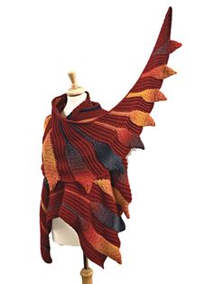 a red and yellow shawl is on a mannequin's dummy head