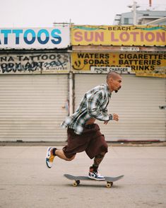 a man riding a skateboard down a street